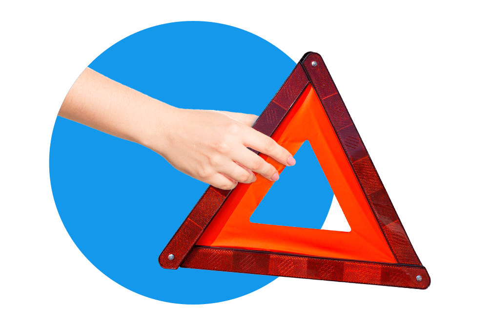 Hand mit einem roten Warndreieck